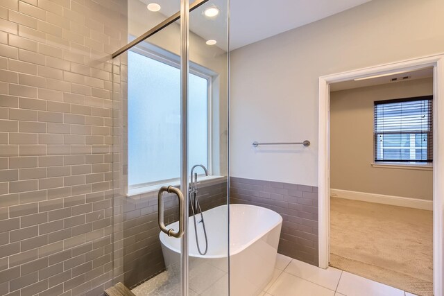 407 N Nagle St Unit E, Houston, TX 77003 - full bath featuring a freestanding tub, a shower stall, tile walls, tile patterned floors, and recessed lighting