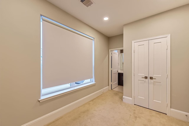 407 N Nagle St Unit E, Houston, TX 77003 - unfurnished bedroom featuring a closet, light colored carpet, baseboards, and recessed lighting