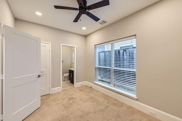 407 N Nagle St Unit E, Houston, TX 77003 - unfurnished bedroom with connected bathroom, recessed lighting, light colored carpet, baseboards, and a ceiling fan
