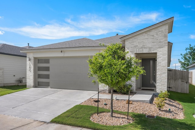 1242 Amistad Loop, College Station, TX 77845 - contemporary house with a garage, concrete driveway, stone siding, and roof with shingles