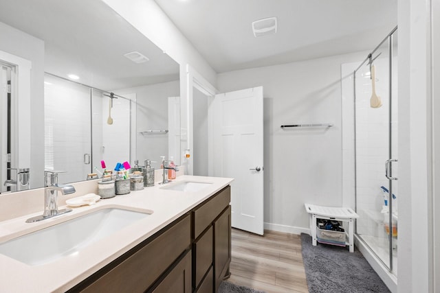 1242 Amistad Loop, College Station, TX 77845 - bathroom with a stall shower, wood finished floors, double vanity, and baseboards