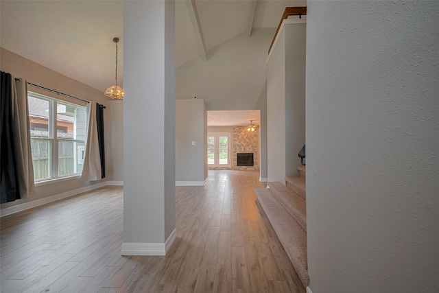 8547 Sparkling Springs Dr, Houston, TX 77095 - corridor featuring beamed ceiling, stairs, light wood-style flooring, high vaulted ceiling, and baseboards