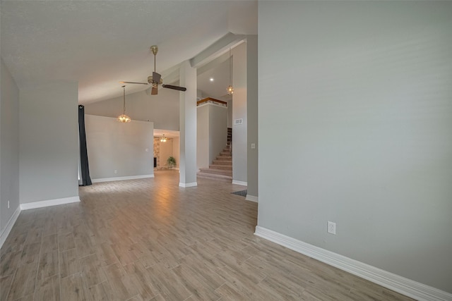 8547 Sparkling Springs Dr, Houston, TX 77095 - empty room with a ceiling fan, baseboards, light wood finished floors, and high vaulted ceiling
