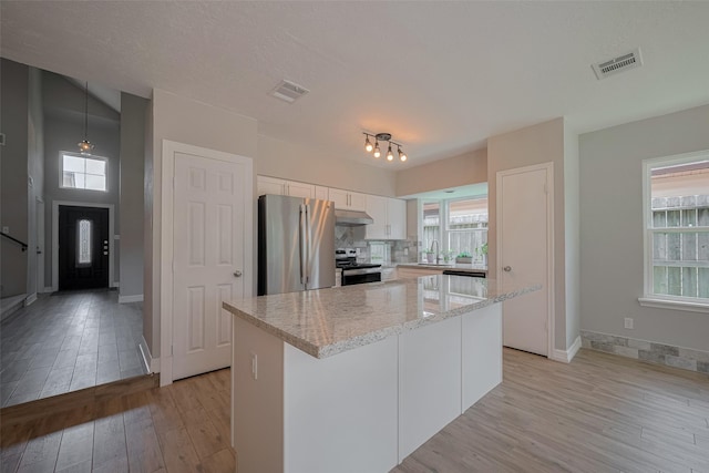 8547 Sparkling Springs Dr, Houston, TX 77095 - kitchen featuring appliances with stainless steel finishes, white cabinetry, light wood-style flooring, and a sink