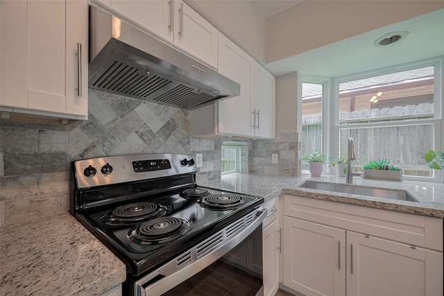 8547 Sparkling Springs Dr, Houston, TX 77095 - kitchen with stainless steel electric stove, under cabinet range hood, a sink, and white cabinetry