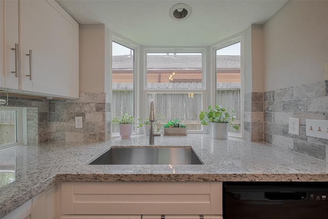 8547 Sparkling Springs Dr, Houston, TX 77095 - kitchen featuring black dishwasher, a sink, white cabinets, and backsplash
