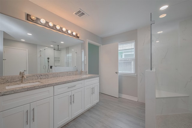 8547 Sparkling Springs Dr, Houston, TX 77095 - bathroom featuring a marble finish shower, double vanity, baseboards, and recessed lighting