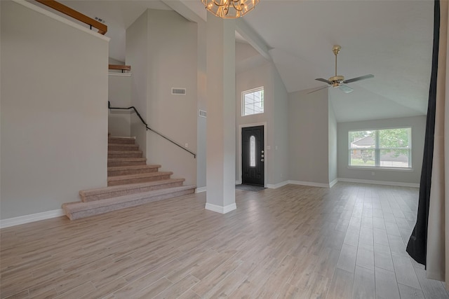 8547 Sparkling Springs Dr, Houston, TX 77095 - foyer entrance with healthy amount of natural light, stairs, baseboards, high vaulted ceiling, and light wood finished floors
