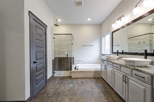 28723 Eden Creek Trl, Fulshear, TX 77441 - bathroom featuring a stall shower, a garden tub, double vanity, and wood finished floors