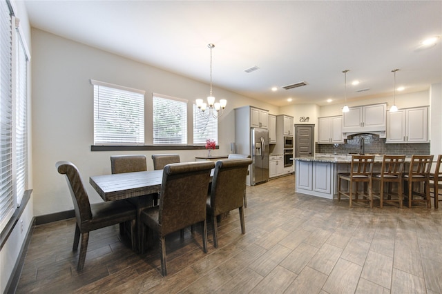 28723 Eden Creek Trl, Fulshear, TX 77441 - dining area featuring a chandelier, wood finished floors, and recessed lighting