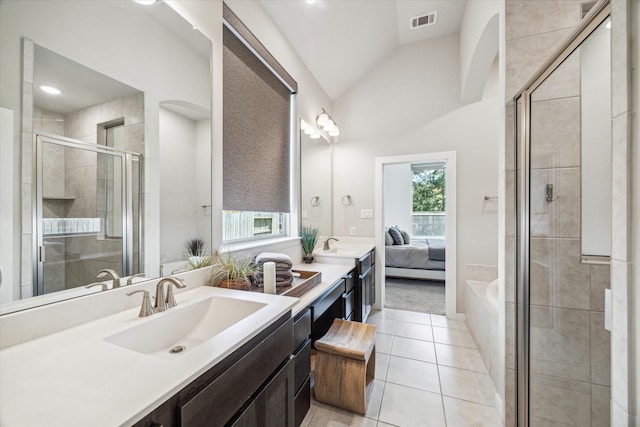16707 Ramsay Cascades Dr, Humble, TX 77346 - ensuite bathroom featuring tile patterned floors, a shower stall, vaulted ceiling, double vanity, and a bath