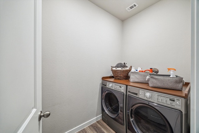 16707 Ramsay Cascades Dr, Humble, TX 77346 - laundry area with washing machine and clothes dryer, wood finished floors, and baseboards
