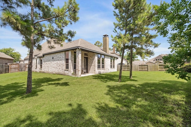 16707 Ramsay Cascades Dr, Humble, TX 77346 - back of house with a chimney and brick siding