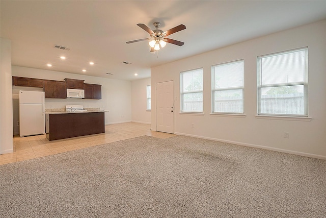 unfurnished living room featuring ceiling fan, recessed lighting, baseboards, and light colored carpet