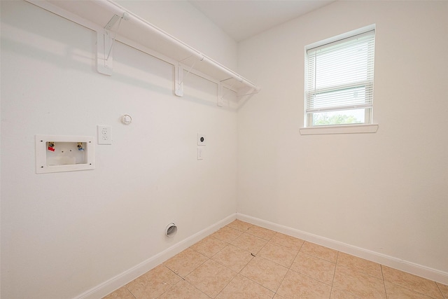 laundry room featuring hookup for an electric dryer, washer hookup, gas dryer hookup, baseboards, and light tile patterned floors