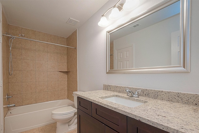 bathroom featuring toilet, vanity, bathing tub / shower combination, and tile patterned flooring