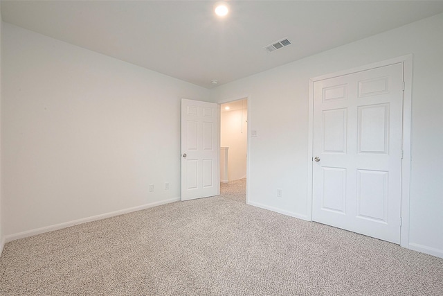 unfurnished bedroom featuring carpet and baseboards