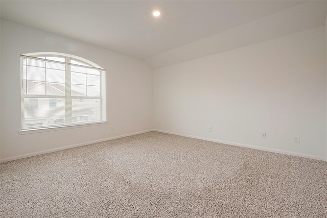 unfurnished room featuring carpet, vaulted ceiling, baseboards, and recessed lighting