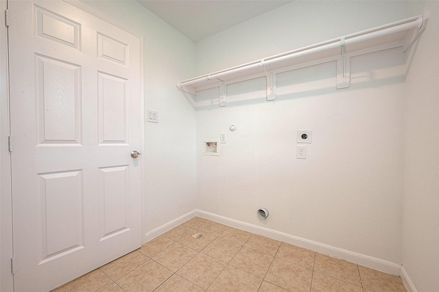 clothes washing area featuring electric dryer hookup, baseboards, hookup for a washing machine, light tile patterned floors, and hookup for a gas dryer