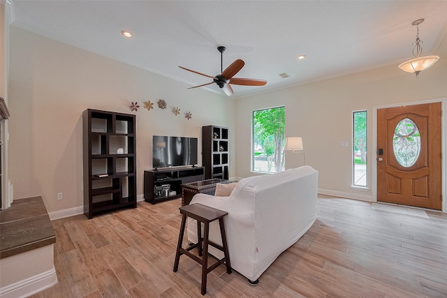14844 Pollux Dr, Willis, TX 77318 - living area featuring light wood-style floors, ceiling fan, baseboards, recessed lighting, and crown molding
