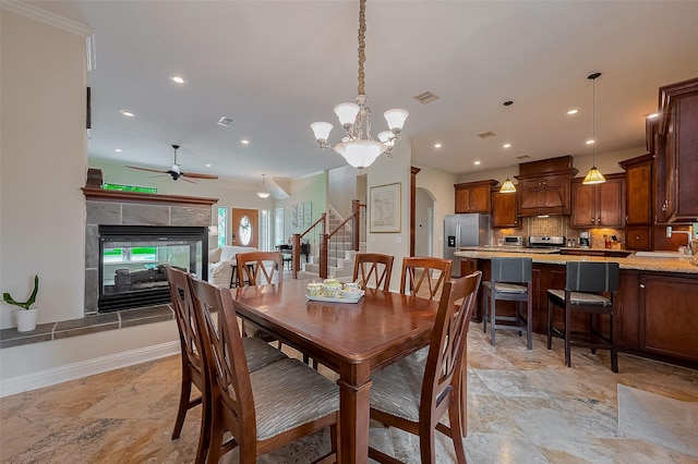 14844 Pollux Dr, Willis, TX 77318 - dining room with a ceiling fan, a fireplace, arched walkways, recessed lighting, and stairs