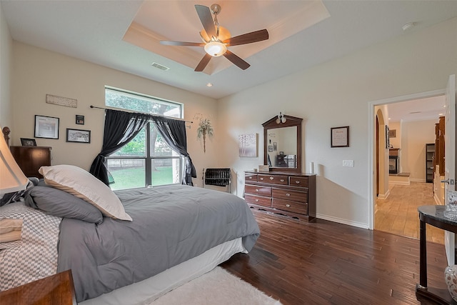 14844 Pollux Dr, Willis, TX 77318 - bedroom featuring hardwood / wood-style floors, a raised ceiling, ceiling fan, and baseboards