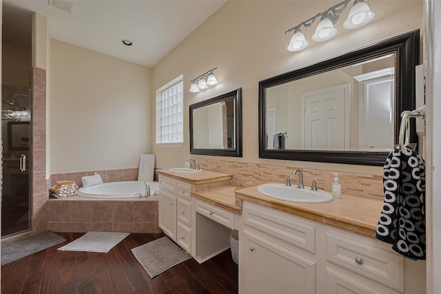 14844 Pollux Dr, Willis, TX 77318 - bathroom featuring a bath, vanity, a shower stall, wood finished floors, and tasteful backsplash