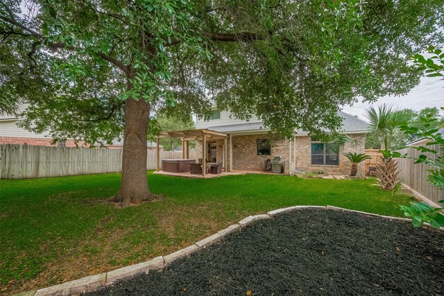 14844 Pollux Dr, Willis, TX 77318 - rear view of house with a jacuzzi, a patio area, and brick siding
