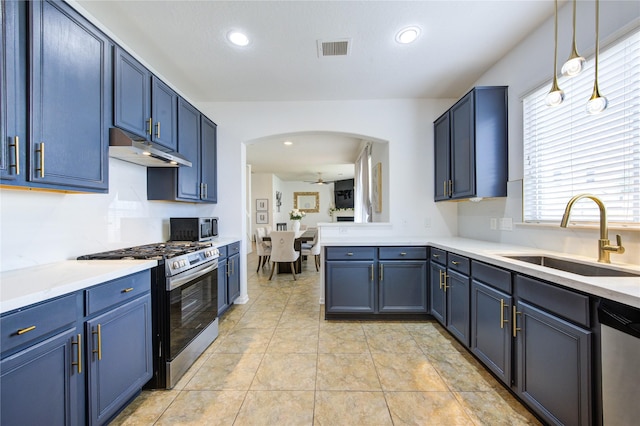 4806 Vintage Grove Ct, Katy, TX 77449 - kitchen featuring a sink, stainless steel appliances, under cabinet range hood, arched walkways, and blue cabinets