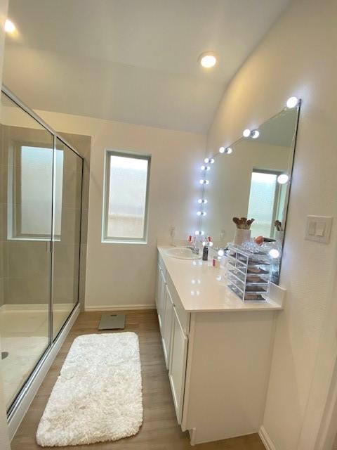 1926 Barrett Gables Dr, Crosby, TX 77532 - full bathroom with a shower stall, lofted ceiling, baseboards, vanity, and wood finished floors