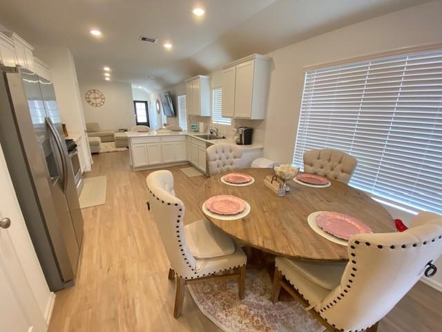 1926 Barrett Gables Dr, Crosby, TX 77532 - dining area with light wood-type flooring and recessed lighting