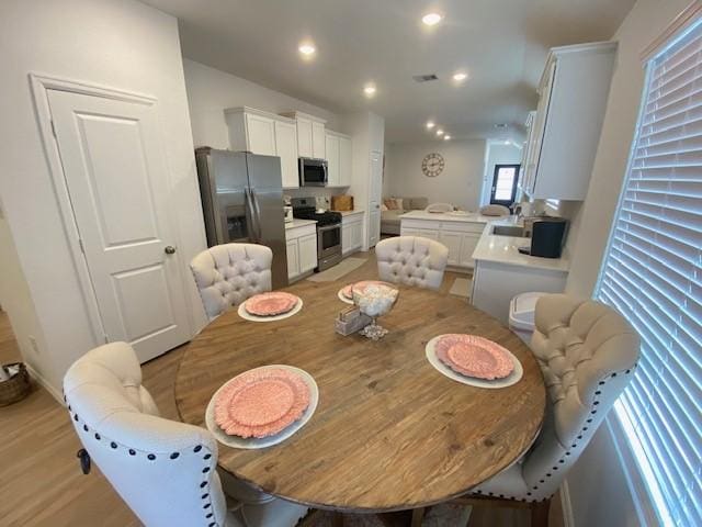 1926 Barrett Gables Dr, Crosby, TX 77532 - dining room with light wood finished floors and recessed lighting