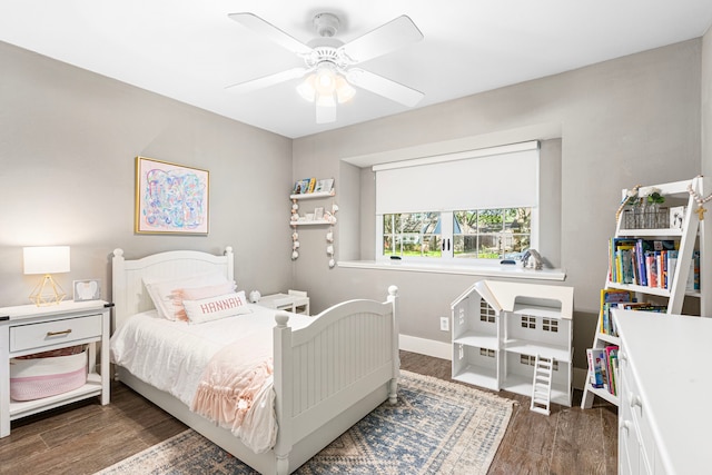 bedroom featuring wood finished floors, baseboards, and ceiling fan