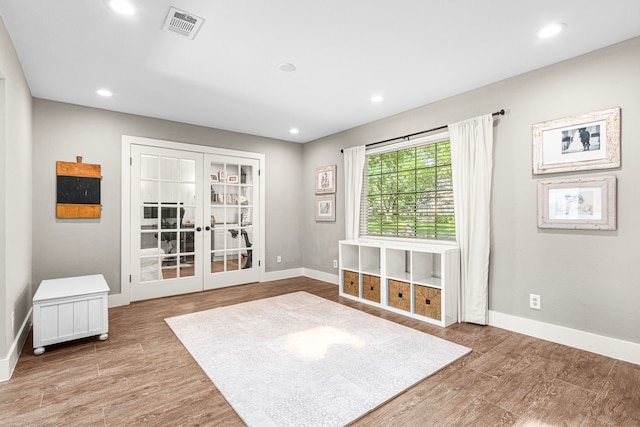 spare room featuring baseboards, french doors, wood finished floors, and recessed lighting