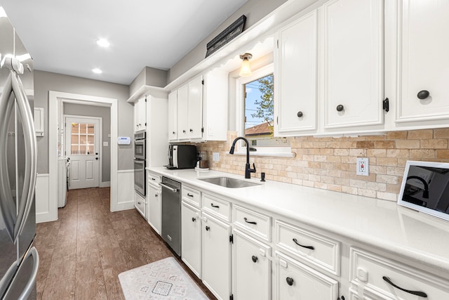 kitchen featuring a sink, appliances with stainless steel finishes, white cabinetry, and recessed lighting