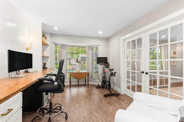 office featuring french doors, wood finished floors, built in study area, baseboards, and recessed lighting