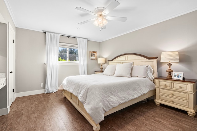 bedroom featuring dark wood-style floors, crown molding, baseboards, and a ceiling fan