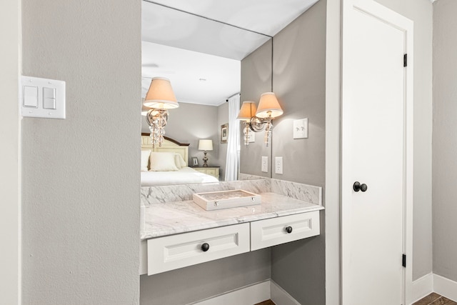 ensuite bathroom with baseboards and vanity