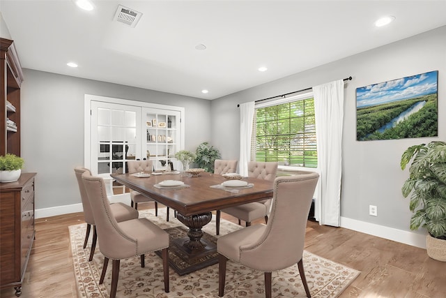 dining room featuring baseboards, light wood-style flooring, and recessed lighting