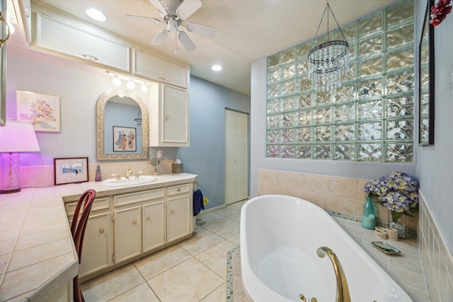 4114 Plumtree Ln, Seabrook, TX 77586 - full bathroom with a jetted tub, vanity, ceiling fan, and tile patterned flooring