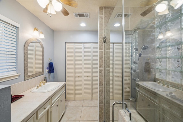 4114 Plumtree Ln, Seabrook, TX 77586 - bathroom featuring ceiling fan, a closet, two vanities, and a shower stall