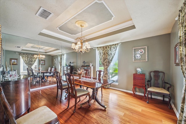 4114 Plumtree Ln, Seabrook, TX 77586 - dining room with a raised ceiling, a chandelier, wood finished floors, baseboards, and a textured ceiling