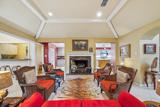4114 Plumtree Ln, Seabrook, TX 77586 - living area featuring vaulted ceiling, tile patterned flooring, a premium fireplace, arched walkways, and baseboards