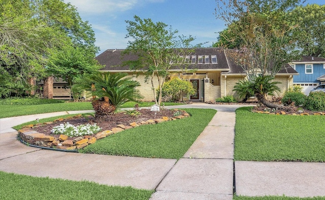 4114 Plumtree Ln, Seabrook, TX 77586 - view of front facade with brick siding, a front yard, and roof with shingles