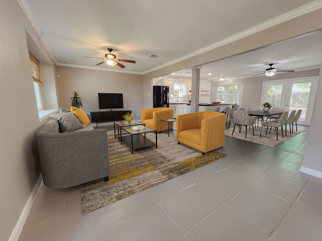 11106 Sagevalley Dr N, Houston, TX 77089 - living room with ceiling fan, baseboards, crown molding, decorative columns, and tile patterned flooring