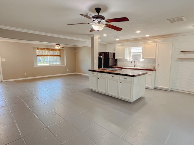 11106 Sagevalley Dr N, Houston, TX 77089 - kitchen featuring crown molding, freestanding refrigerator, a ceiling fan, plenty of natural light, and decorative backsplash