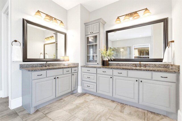 30622 Indigo Falls Dr, Brookshire, TX 77423 - full bathroom featuring two vanities and a shower with door