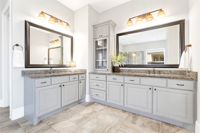 30622 Indigo Falls Dr, Fulshear, TX 77423 - bathroom featuring two vanities and a shower with door