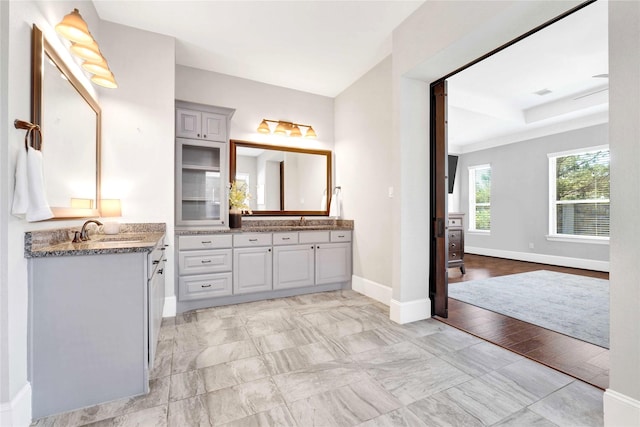 30622 Indigo Falls Dr, Brookshire, TX 77423 - bathroom featuring baseboards, two vanities, and marble finish flooring