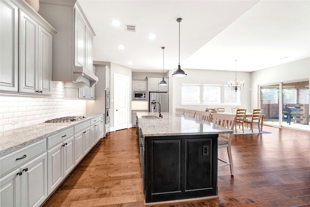 30622 Indigo Falls Dr, Brookshire, TX 77423 - kitchen with a sink, stainless steel appliances, a kitchen breakfast bar, tasteful backsplash, and recessed lighting